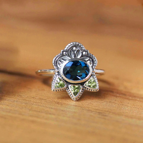 Athena Ring Metalicious Jewelry The ring is made from sterling silver and is set with a beautiful 8x6mm oval London Blue Topaz and three 3mm trillion Peridot.   Recycled metals and ethically sourced gemstones. Jewelry for her. Jewelry near me