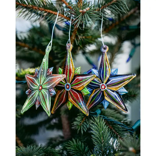 Elegantly decorate your tree this holiday season with this set of 3 Painted Star Ornaments. Handcrafted at the Village Artistique de Noailles in Croix-des-Bouquets, Haiti by Haitian metal artist Jimmy Dade. Steel metal art coated with a gloss varnish and painted  Dimensions: 4