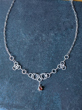 Load image into Gallery viewer, It makes clean, stong bonds and an interesting molten metal texture, plus it brings out the brightness and tarnish-resistance in the Argentium Silver. This necklace incorporated many steps of fusing, forming and fusing again before the pieces were finally linked together. Dimensions and Materials: Solid Argentium Silver 1.1 ct Natural Ethically Sourced Hessonite Garnet 21&quot; long with lobster clasp

