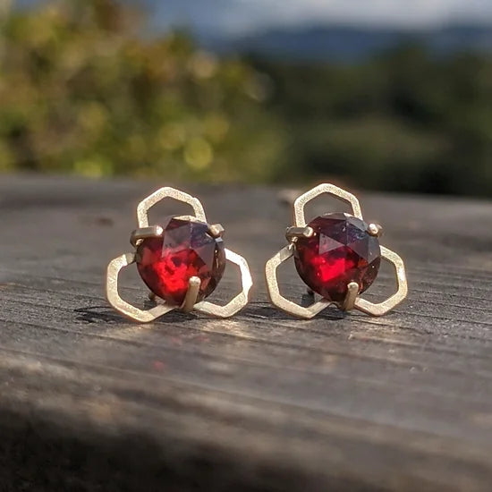  Individually handmade with recycled gold and ethically sourced garnets from Mozambique.  These have a lovely deep red.   Materials and Dimensions:  Solid 14K Gold with a Matte Finish 3.7 ct Garnets, natural and untreated, Mozambque origin These come with comfy silicone covered 14K butterfly backs.  They're very comfortable and secure, plus they can be worn at any point on the post.