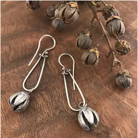 The seed pods of the crepe myrtle are also stunning; split open, they resemble little flowers themselves. Personally, I love the seed pods as much as the flowers!     I cast a crepe myrtle seed pod in sterling silver and hung it from sterling silver hinged loops. The addition of the hinges gives these earrings great movement. These earrings are eye-catching but easy and comfortable to wear.