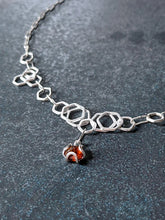 Load image into Gallery viewer,  It makes clean, stong bonds and an interesting molten metal texture, plus it brings out the brightness and tarnish-resistance in the Argentium Silver.  This necklace incorporated many steps of fusing, forming and fusing again before the pieces were finally linked together.    Dimensions and Materials:  Solid Argentium Silver  1.1 ct Natural Ethically Sourced Hessonite Garnet  21&quot; long with lobster clasp. Unique gift for her for anniversary, birthday or Valentine&#39;s Day. Chester Springs, PA. 
