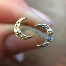 Load image into Gallery viewer, Tiny Crescent studs are perfect for everyday wear. Gold moons with crater/moon texture. Standard post &amp; nut, all 14k gold.  Tiny Crescent Stud, 7mm tall third photo shows sizes of moon studs, Tiny Crescent Stud is in center  Handmade in Colorado using responsibly sourced materials.
