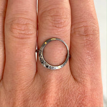 Load image into Gallery viewer, A lyrical moon with three black diamonds and 18k details wraps perfectly around the finger to keep the moon close to you every day. Textured with tiny craters and details. • 18k yellow gold details • Three black diamonds Moon is 5/8” Ring is just over 1/2” at tallest point. This ring is made to order, please allow 2-3 weeks for it to be built to your exact size. Made in Colorado with carefully sourced materials, including recycled silver and reclaimed black diamonds.
