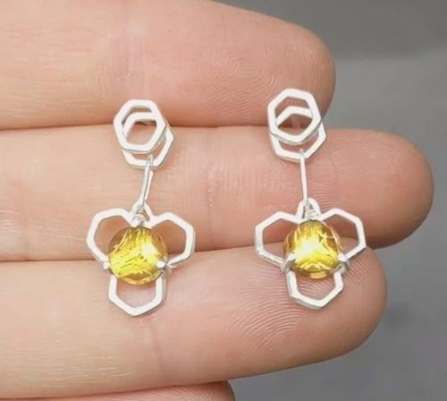 Hexagons formed by hand and fused together create these one of a kind Honey Drop Earrings.  These have matched Citrine Stones, they're a nice Yellow tone that changes depending on the light.  Easy to wear, these are on stacked hex studs and sway with your movement yet are very secure.  Materials: Argentium Silver   Stones:  Citrine Stone Pair 