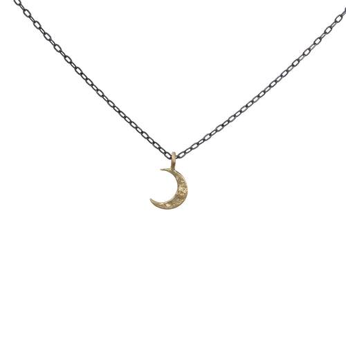Perfect little crescent moon charm necklace, great for layering or wearing on it’s own. Solid 14k yellow gold moon, on an oxidized sterling silver chain  Handmade clasp & catch. Charm moves freely on chain. chain: 17.5” length. charm: 1/4” long  Handmade in Colorado with carefully sourced materials.