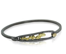 Load image into Gallery viewer, Elongated Pond Bracelet features our hinged loop clasp, which swings up for sliding into, then down to lock into place.   Hand fabricated in textured oxidized sterling silver and 18k yellow gold --with an 18k gold pebble on the hook.   Metals: Oxidized sterling silver and 18k yellow gold Bracelet dimensions: W x 14.7mm L
