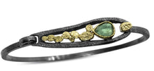 Load image into Gallery viewer, Our one-of-a-kind Green Tourmaline Pond Bracelet, features a hinged loop clasp, which swings up for sliding into, then down to lock into place.   Hand fabricated in textured oxidized sterling silver and 18k yellow gold  Metals: Oxidized sterling silver and 18k yellow gold Stones: Green Tourmaline
