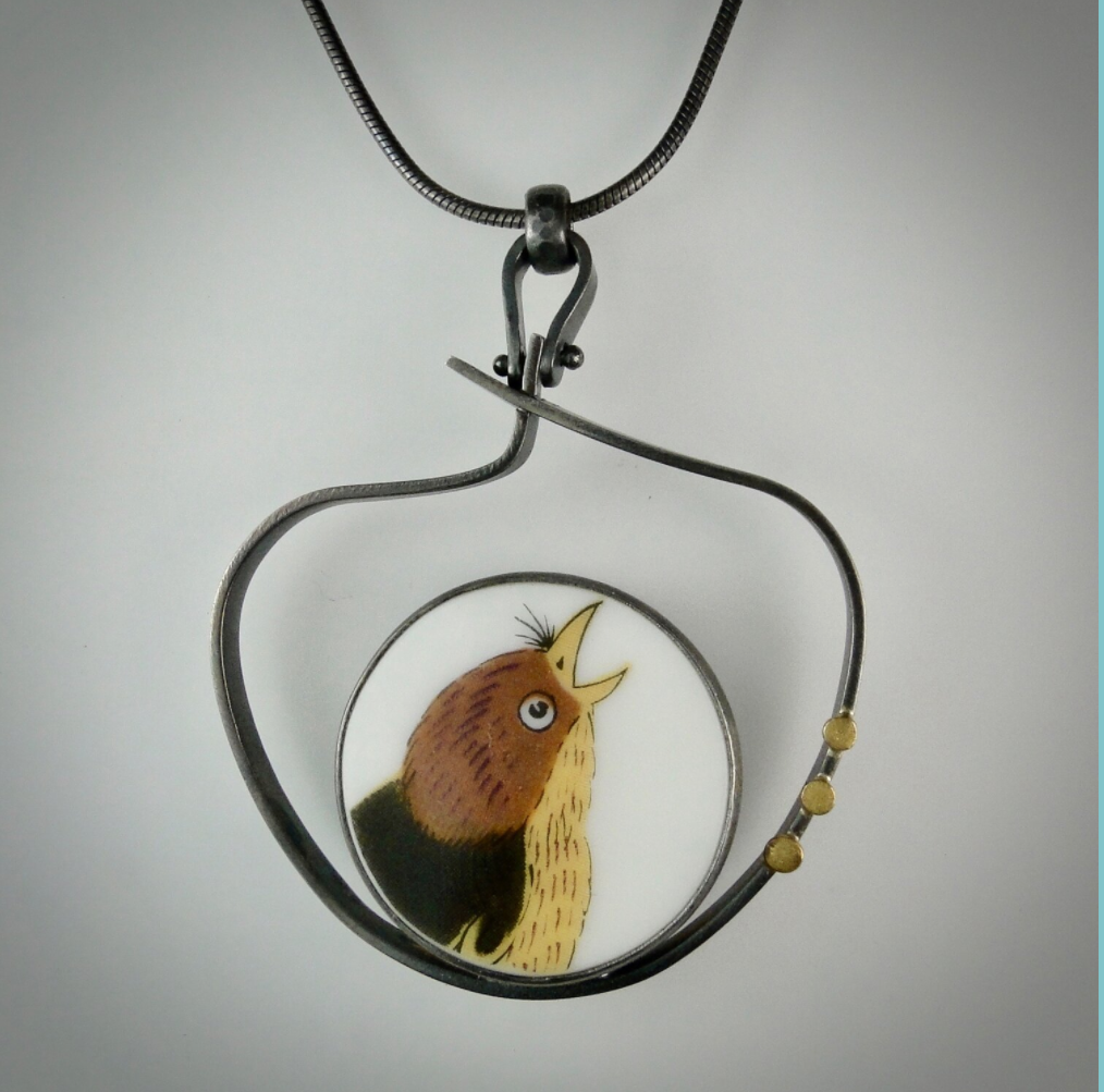 Beautiful Singing Bird Pendant. A porcelain bird nested in a one of a kind oxidized sterling silver nest. 3 18K gold dots serve as an elegant accent. This pendant is a large statement piece for the bird lover in your life!