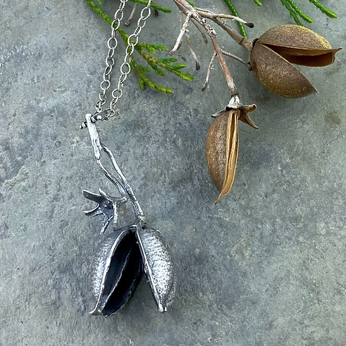 An Empress tree seed pod is cast in sterling silver and hangs from a textured sterling silver box chain.  The Empress tree is a pioneer plant; its tolerance and flexibility allow it to thrive where other trees cannot. Its nitrogen-rich leaves gradually create a more welcoming habitat for other plants to follow. The tree is stunning in spring when it’s covered in vibrant purple blooms. But to me, its winged seed pods are even more intriguing.
