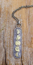Load image into Gallery viewer,  It is a beautiful, handmade charm made of recycled, Sterling Silver with the phases of the Moons accented in 22kt Genuine Gold.  I love the two toned effect that makes this long necklace perfect for layering with either Silver or Gold necklaces at different levels.    The long, rectangular charm is about 2 1/2 long including the bail.  I added to the artisan charm of this design, but making a long coil of Sterling Beads that embellish the outline of this charm.  
