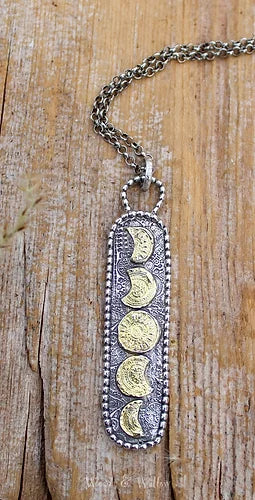  It is a beautiful, handmade charm made of recycled, Sterling Silver with the phases of the Moons accented in 22kt Genuine Gold.  I love the two toned effect that makes this long necklace perfect for layering with either Silver or Gold necklaces at different levels.    The long, rectangular charm is about 2 1/2 long including the bail.  I added to the artisan charm of this design, but making a long coil of Sterling Beads that embellish the outline of this charm.  